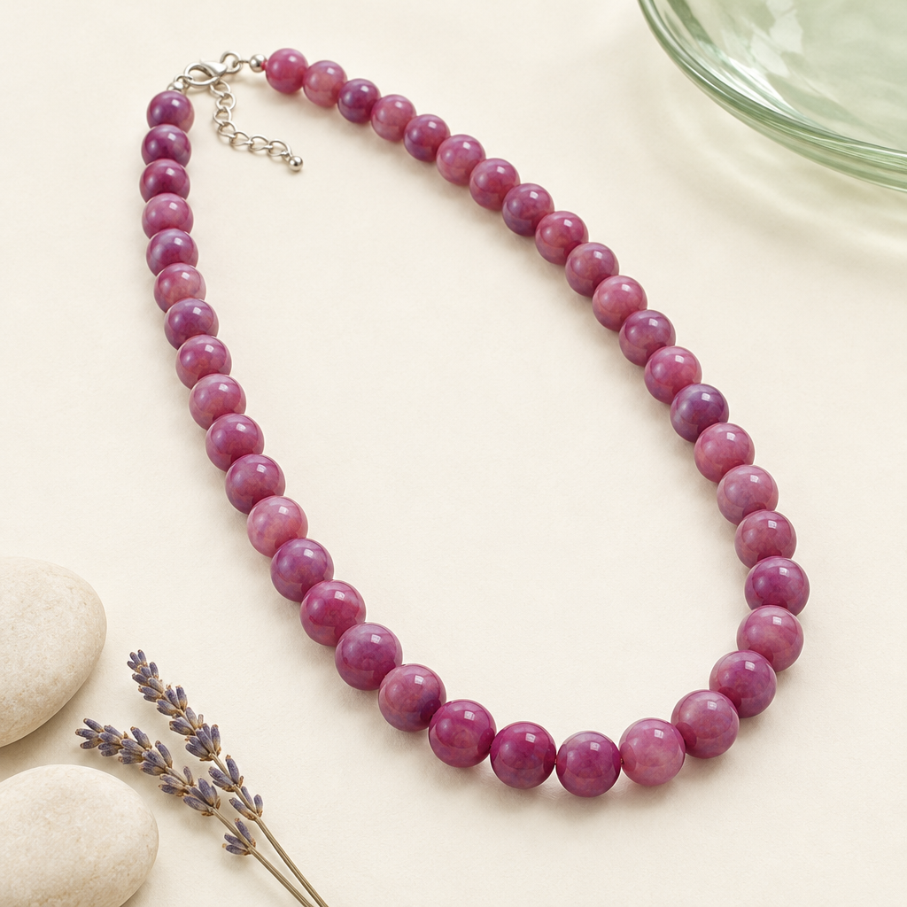 Flieder-violett marmorierte Perlenkette mit glatten Rundperlen auf cremefarbener Keramik mit salbeigrünem Glas, hellen Steinen und Lavendel